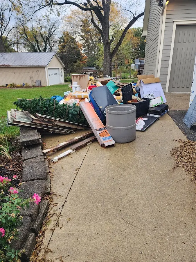 Dumpster being loaded with debris for Estate Cleanout Dumpster Rental in Bowling Green